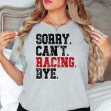 a woman with long hair wearing a gray shirt