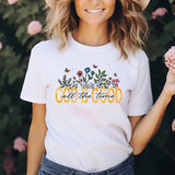 a woman wearing a white t - shirt with the words god in god on it