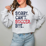 a woman wearing a sweatshirt that says sorry can't soccer bye