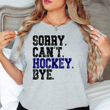 a woman wearing a grey shirt that says sorry can't hockey bye