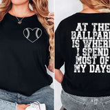a woman wearing a black shirt that says at the ballpark is where i spend