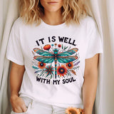 a woman wearing a t - shirt that says it is well with my soul
