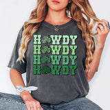 a woman sitting on the ground wearing a gray shirt with green lettering