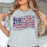 a woman wearing a grey shirt that says support american farmers