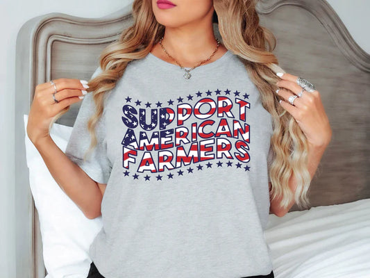 a woman wearing a grey shirt that says support american farmers
