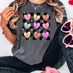 a woman wearing a t - shirt with hearts on it