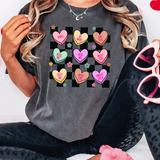 a woman wearing a t - shirt with hearts on it