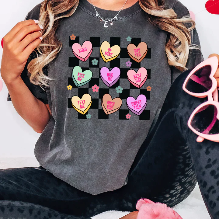 a woman wearing a t - shirt with hearts on it
