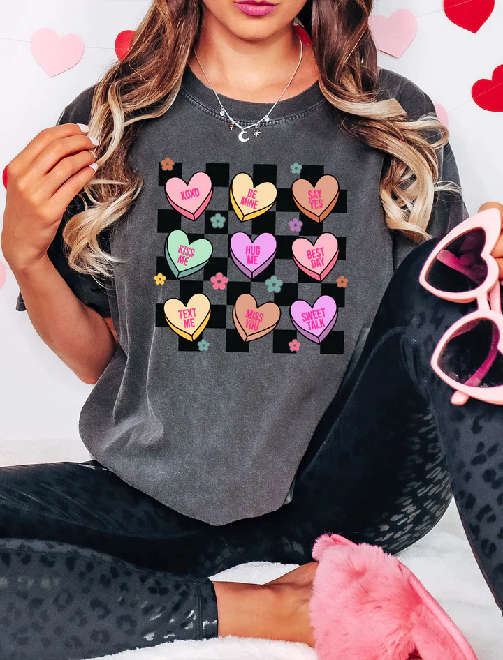 a woman wearing a t - shirt with hearts on it