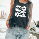 a woman standing on a bed wearing a tank top