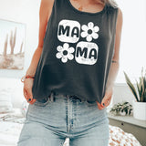 a woman standing on a bed wearing a tank top