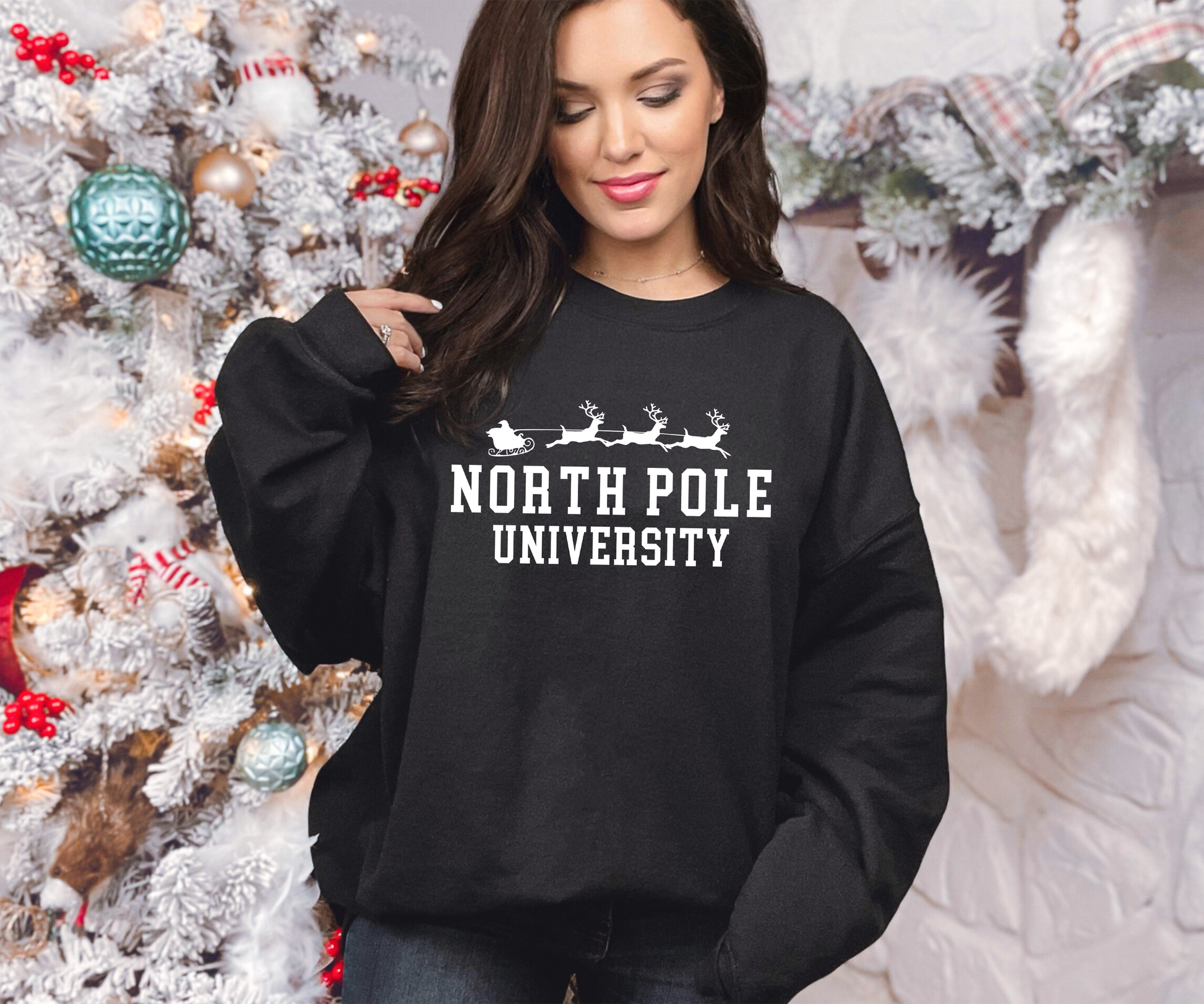 a woman wearing a black sweatshirt that says north pole university