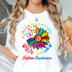 a woman holding a drink and wearing a white t - shirt