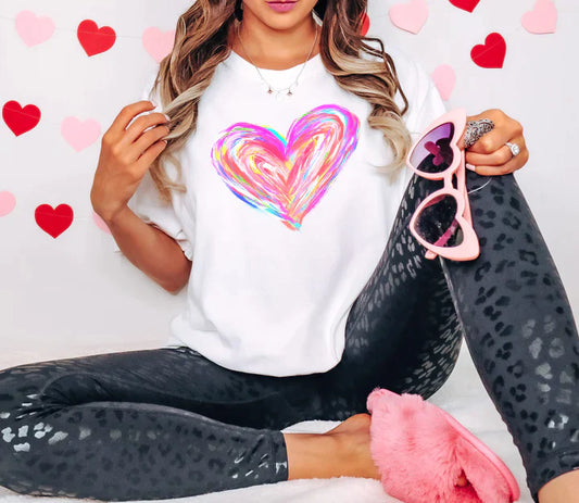 a woman sitting on a bed holding a pair of pink scissors