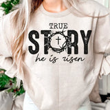 a woman wearing a sweatshirt that says true story he is risen