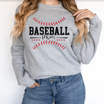 a woman wearing a baseball mom sweatshirt