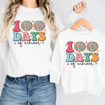a woman wearing a white shirt with the words 100 days of school on it