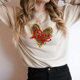 a woman wearing a sweater with a heart on it