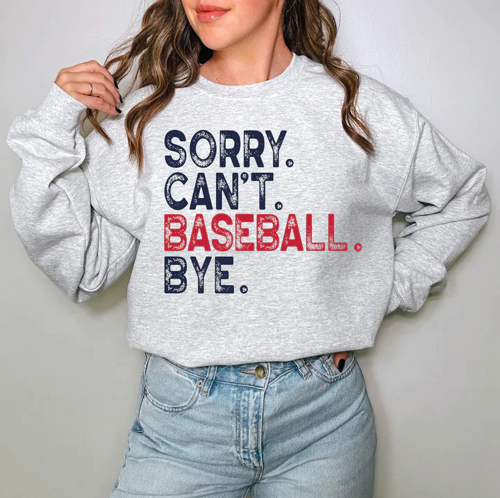 a woman wearing a sweatshirt that says sorry can't baseball bye