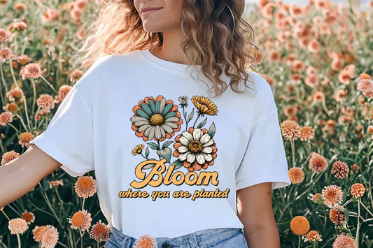 a woman standing in a field of flowers wearing a bloom t - shirt