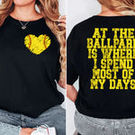 a woman wearing a black shirt with a yellow heart on it