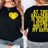 a woman wearing a black shirt with a yellow heart on it