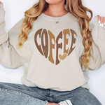 a woman wearing a sweatshirt with the word coffee printed on it