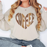 a woman wearing a sweatshirt with the word coffee printed on it