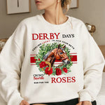 a woman sitting on a bed wearing a sweatshirt