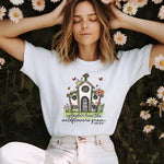 a woman sitting in front of flowers with her hands on her head