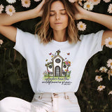 a woman sitting in front of flowers with her hands on her head