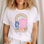 a woman in a white shirt holding a teddy bear