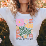 a woman standing in a field of flowers