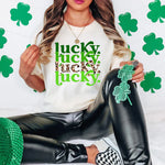 a woman sitting on a bed wearing a t - shirt that says lucky lucky