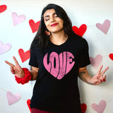 a woman standing in front of a wall with hearts