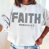a woman wearing a sweatshirt that says faith