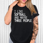 a woman wearing a black shirt that says i like softball and maybe three people
