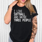 a woman wearing a black shirt that says i like softball and maybe three people