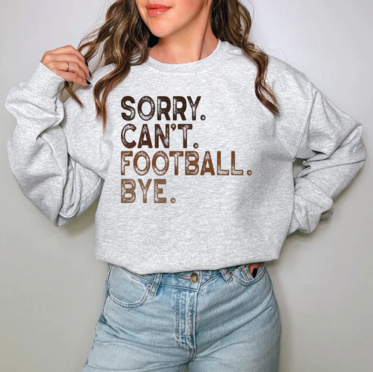 a woman wearing a sweatshirt that says sorry can't football bye