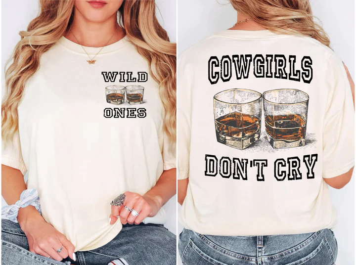 a woman wearing a cowgirl shirt with two glasses of whiskey on it