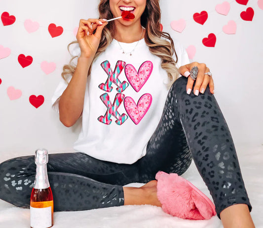 a woman sitting on the floor with a spoon in her mouth