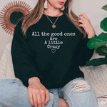 a woman wearing a black sweatshirt that says all the good ones are a little crazy