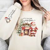 a woman wearing a sweatshirt with a christmas scene on it