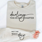 a woman laying on top of a bed holding a t - shirt