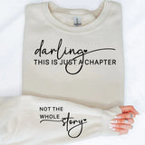 a woman laying on top of a bed holding a t - shirt