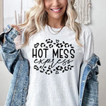 a woman wearing a t - shirt that says hot mess