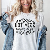 a woman wearing a t - shirt that says hot mess
