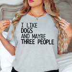 a woman wearing a t - shirt that says i like dogs and maybe three people