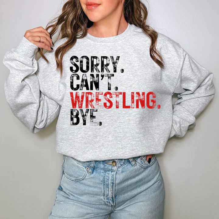 a woman wearing a sweatshirt that says sorry can't wrestling bye