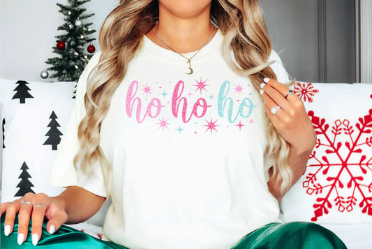 a woman sitting on a couch in front of a christmas tree